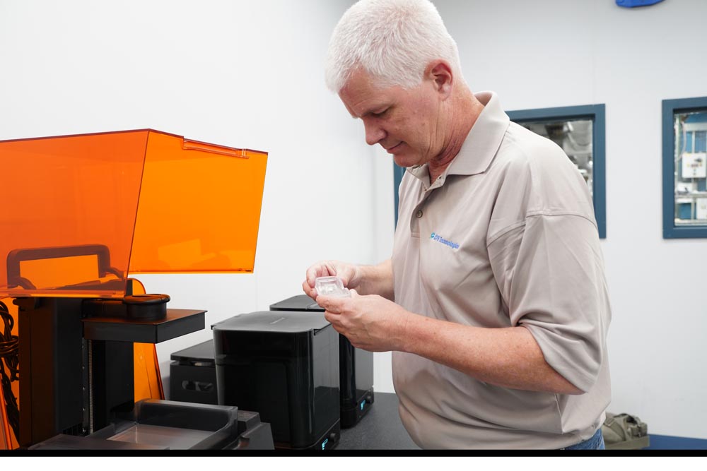 CPS employee inspecting part